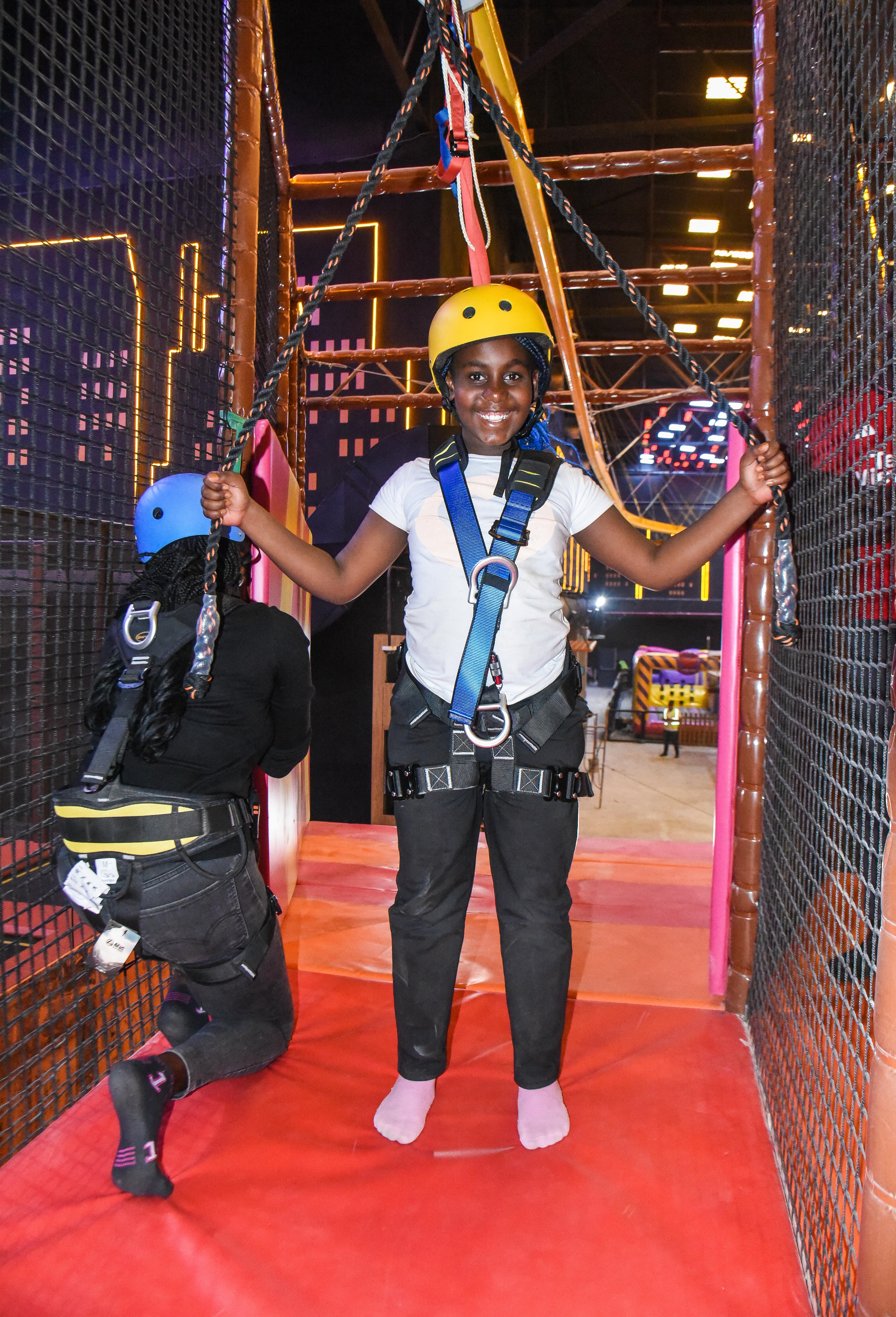 Visitor gliding through the Aerial Glider at The Hub Park, a bounce bounce attraction at Nairobi's funland.