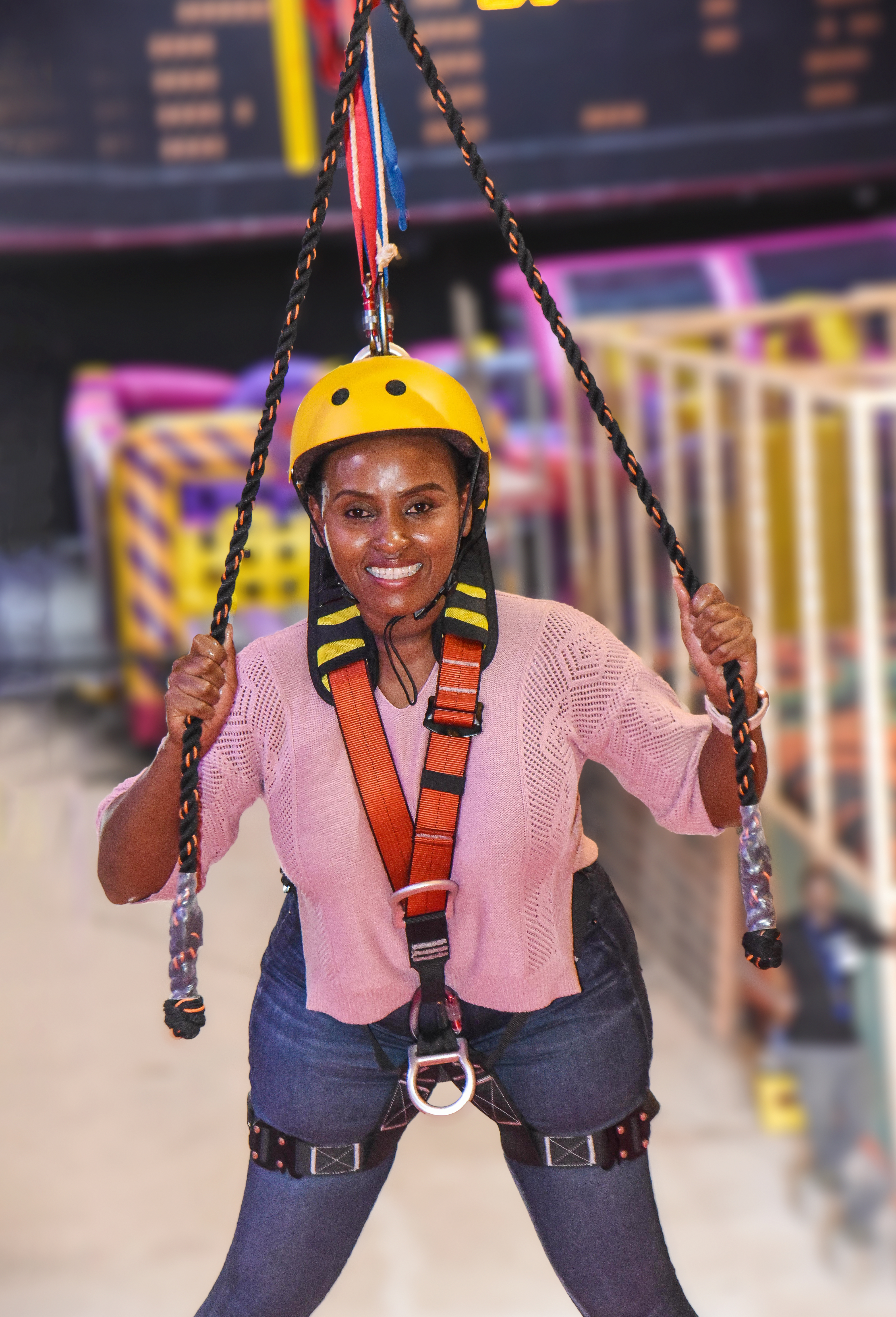 Visitor gliding through the Aerial Glider at The Hub Park, a bounce bounce attraction at Nairobi's funland.