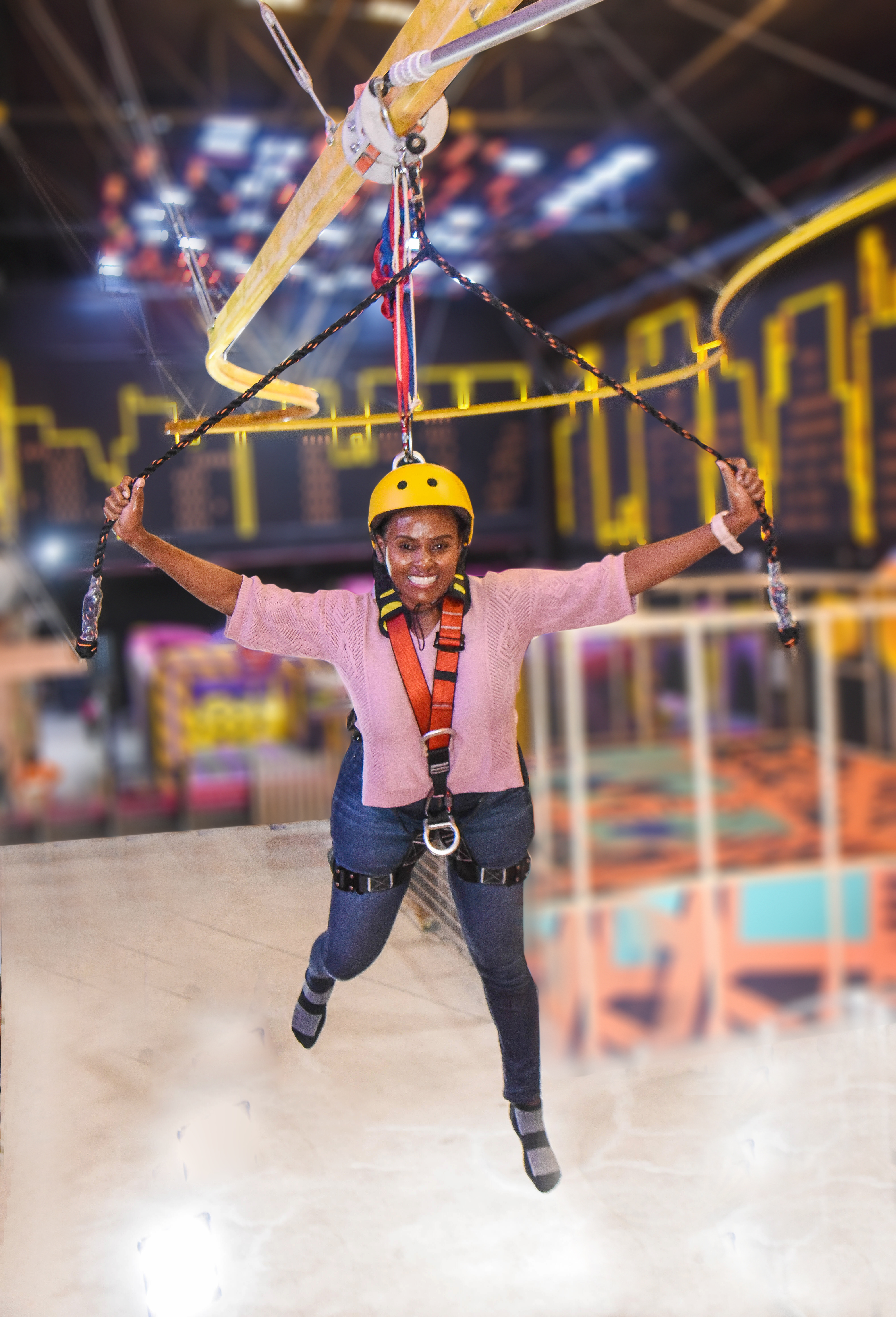 Visitor gliding through the Aerial Glider at The Hub Park, a bounce bounce attraction at Nairobi's funland.