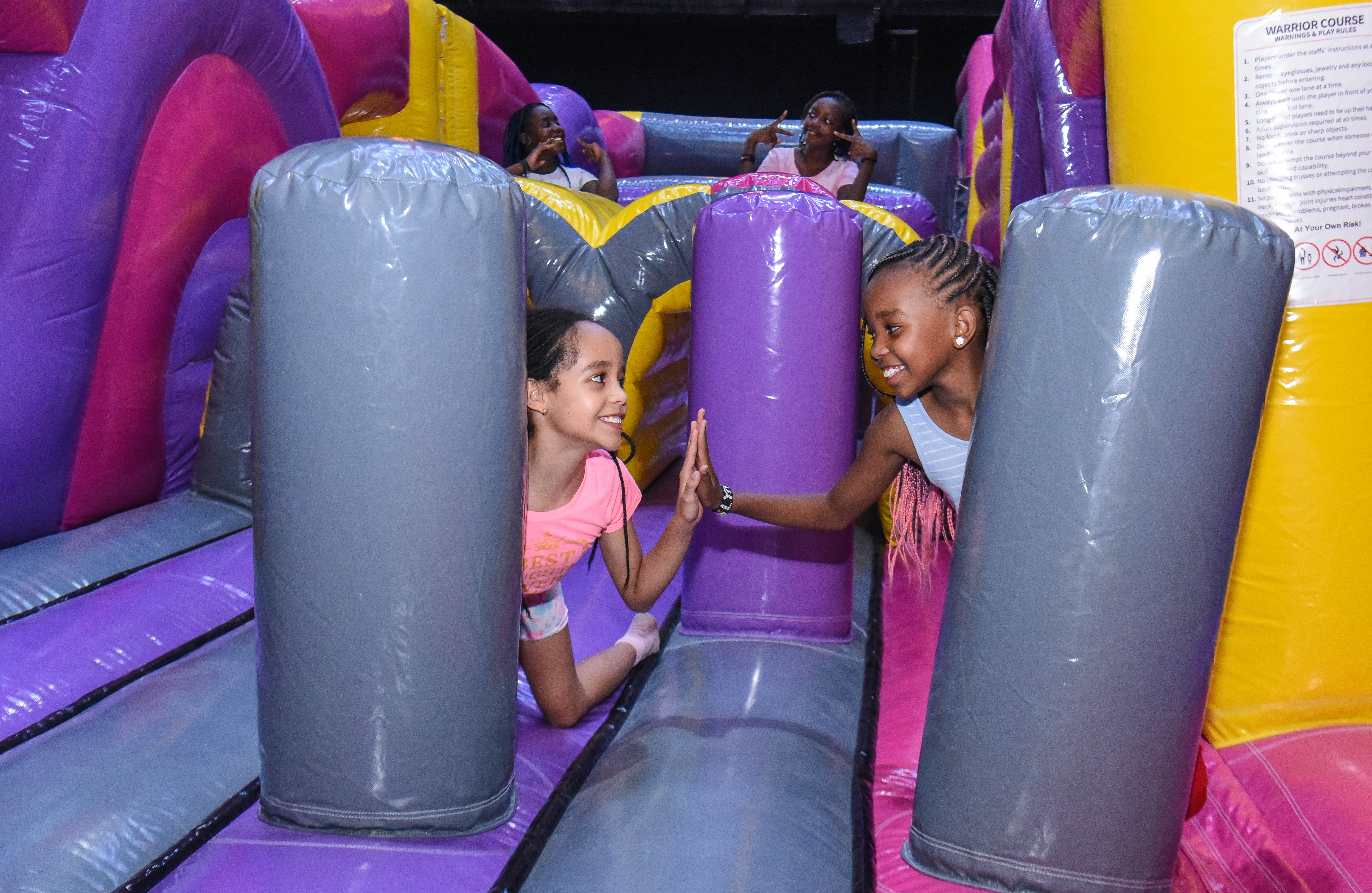 Children enjoying aerial play in the Air Park zone at The Hub Park, an indoor trampoline bounce park near Nairobi.