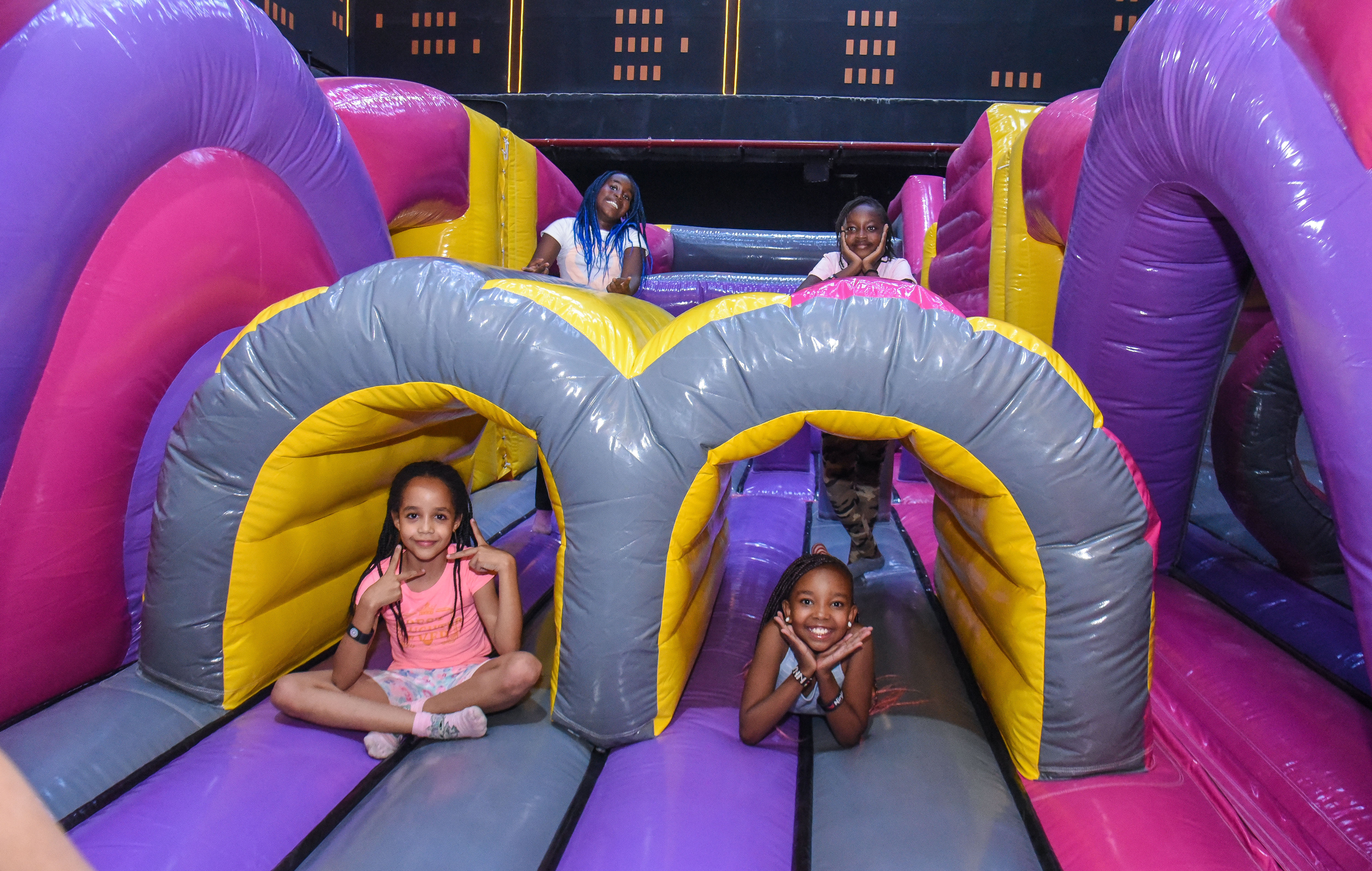 Children enjoying aerial play in the Air Park zone at The Hub Park, an indoor trampoline bounce park near Nairobi.