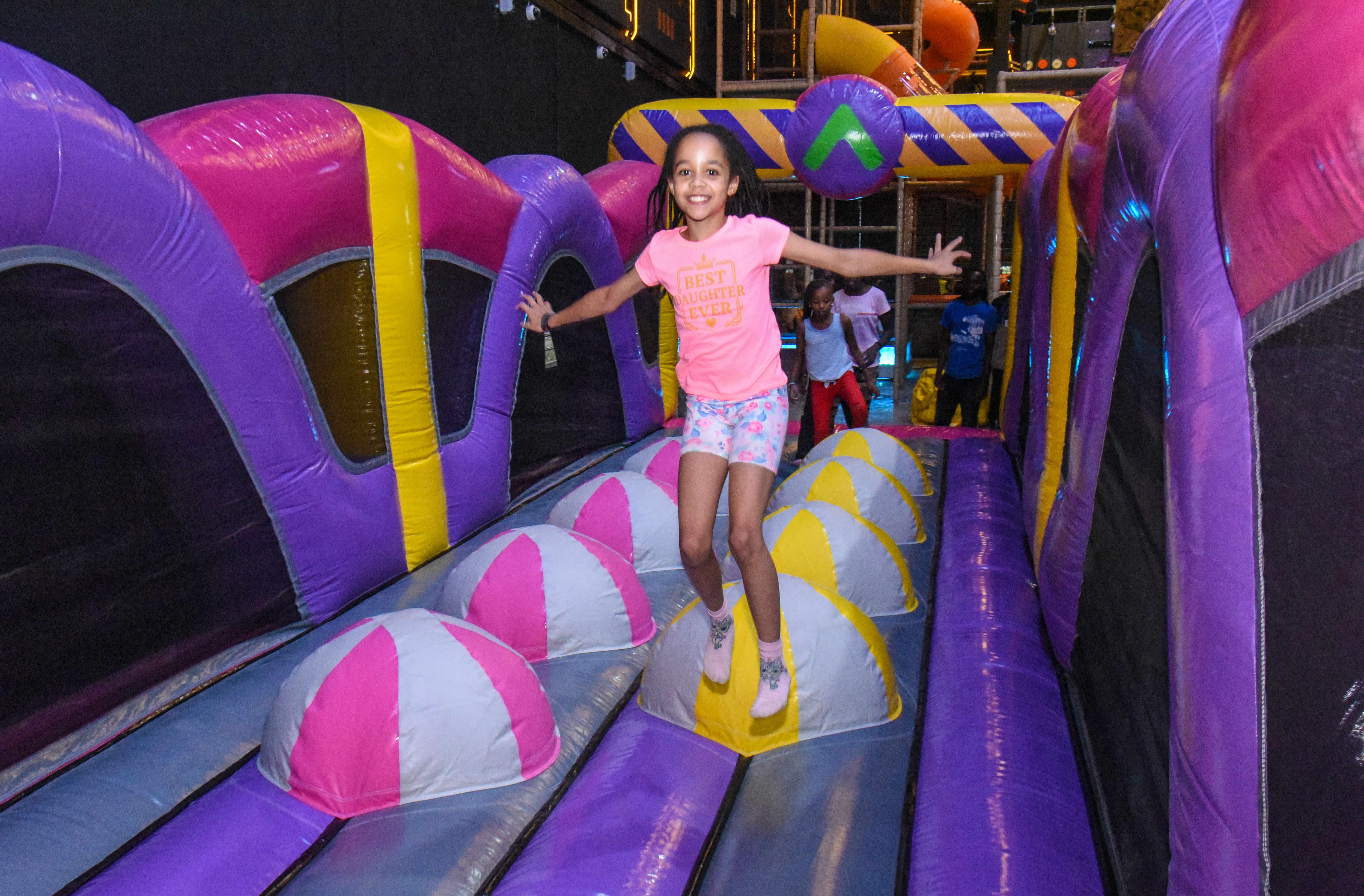 Guest landing on Bag Jump at The Hub Park, a bounce place and game center near me with fun zones for all.