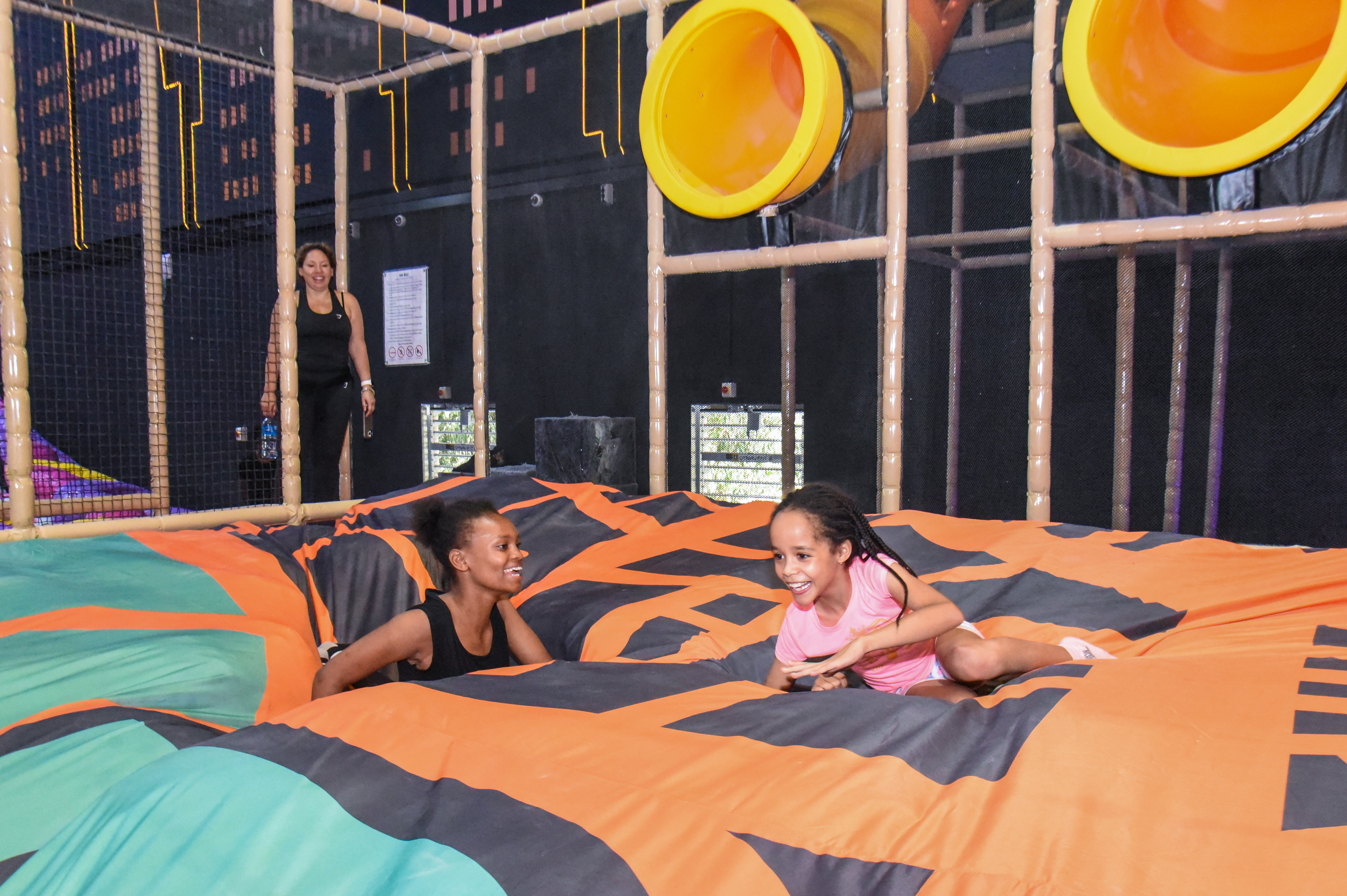 Guest landing on Bag Jump at The Hub Park, a bounce place and game center near me with fun zones for all.