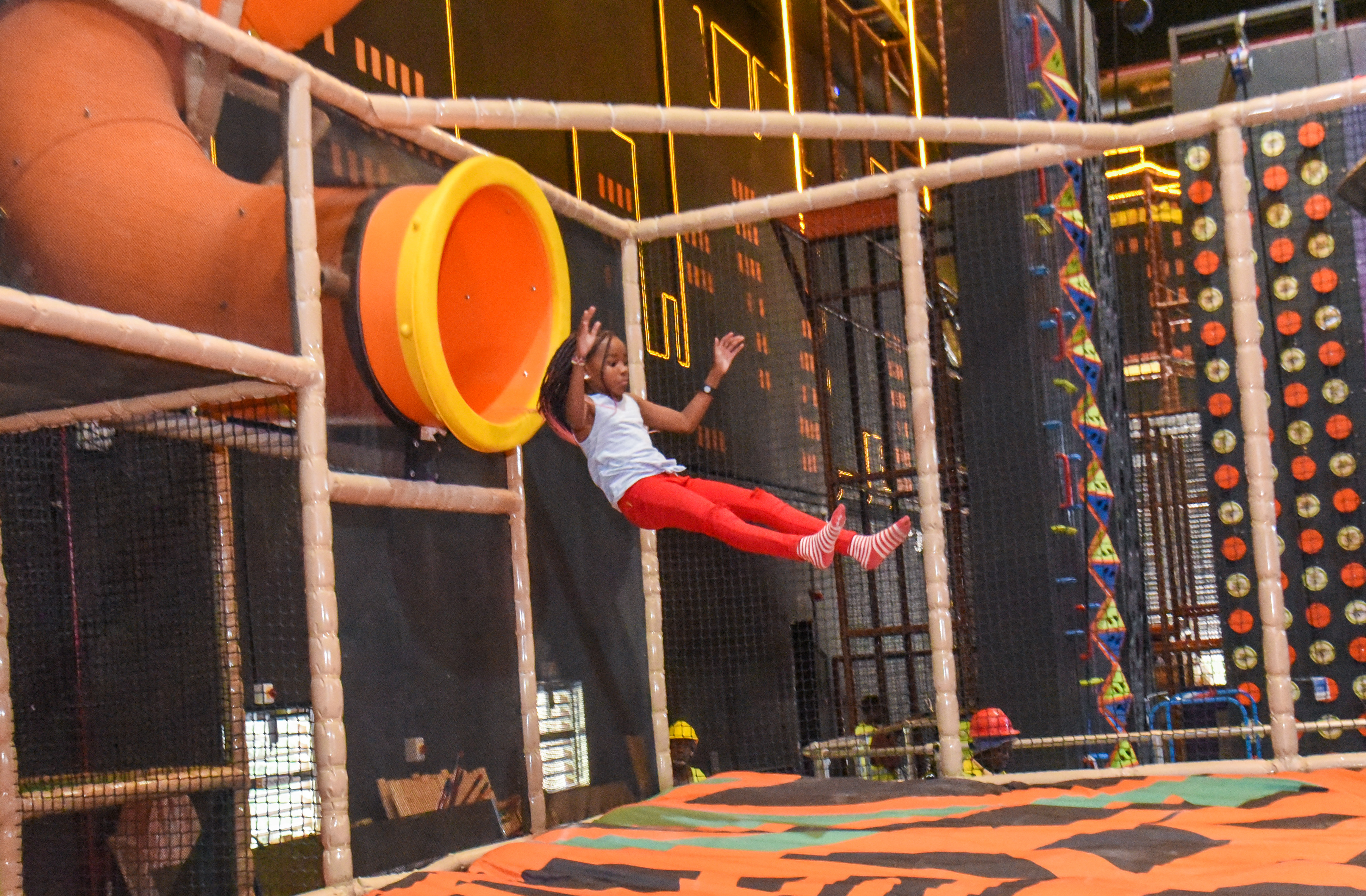 Guest landing on Bag Jump at The Hub Park, a bounce place and game center near me with fun zones for all.