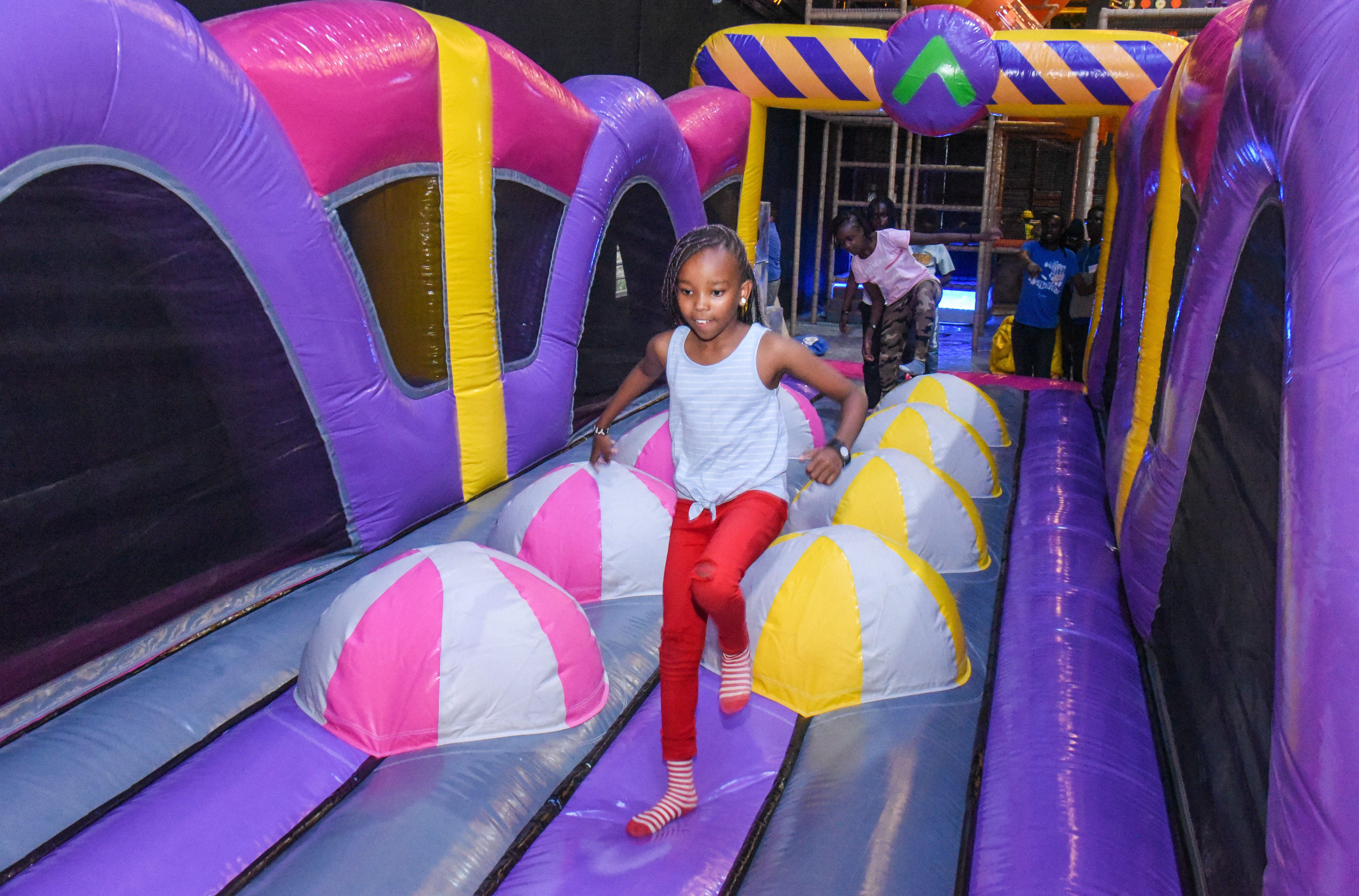 Guest landing on Bag Jump at The Hub Park, a bounce place and game center near me with fun zones for all.