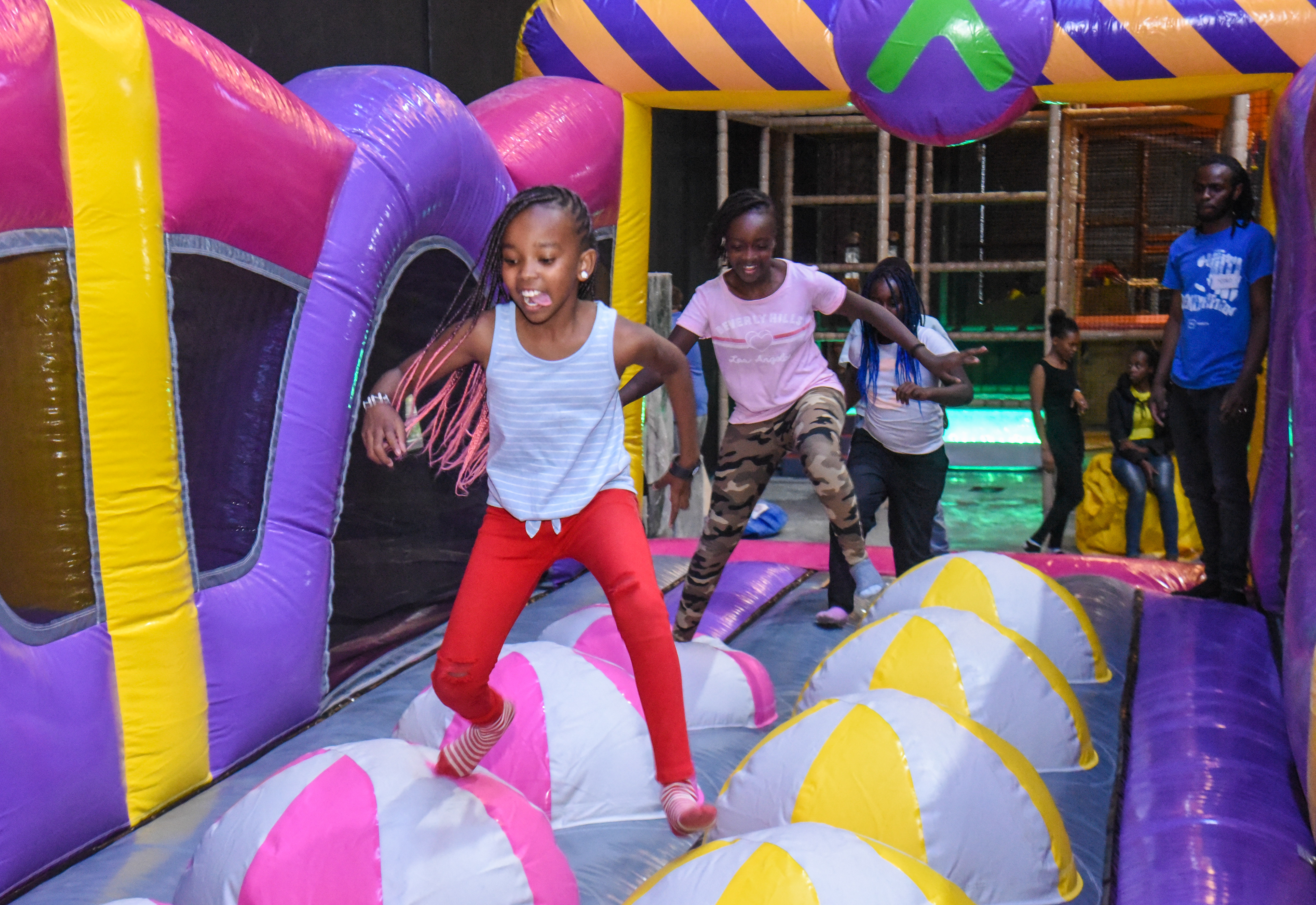 Guest landing on Bag Jump at The Hub Park, a bounce place and game center near me with fun zones for all.