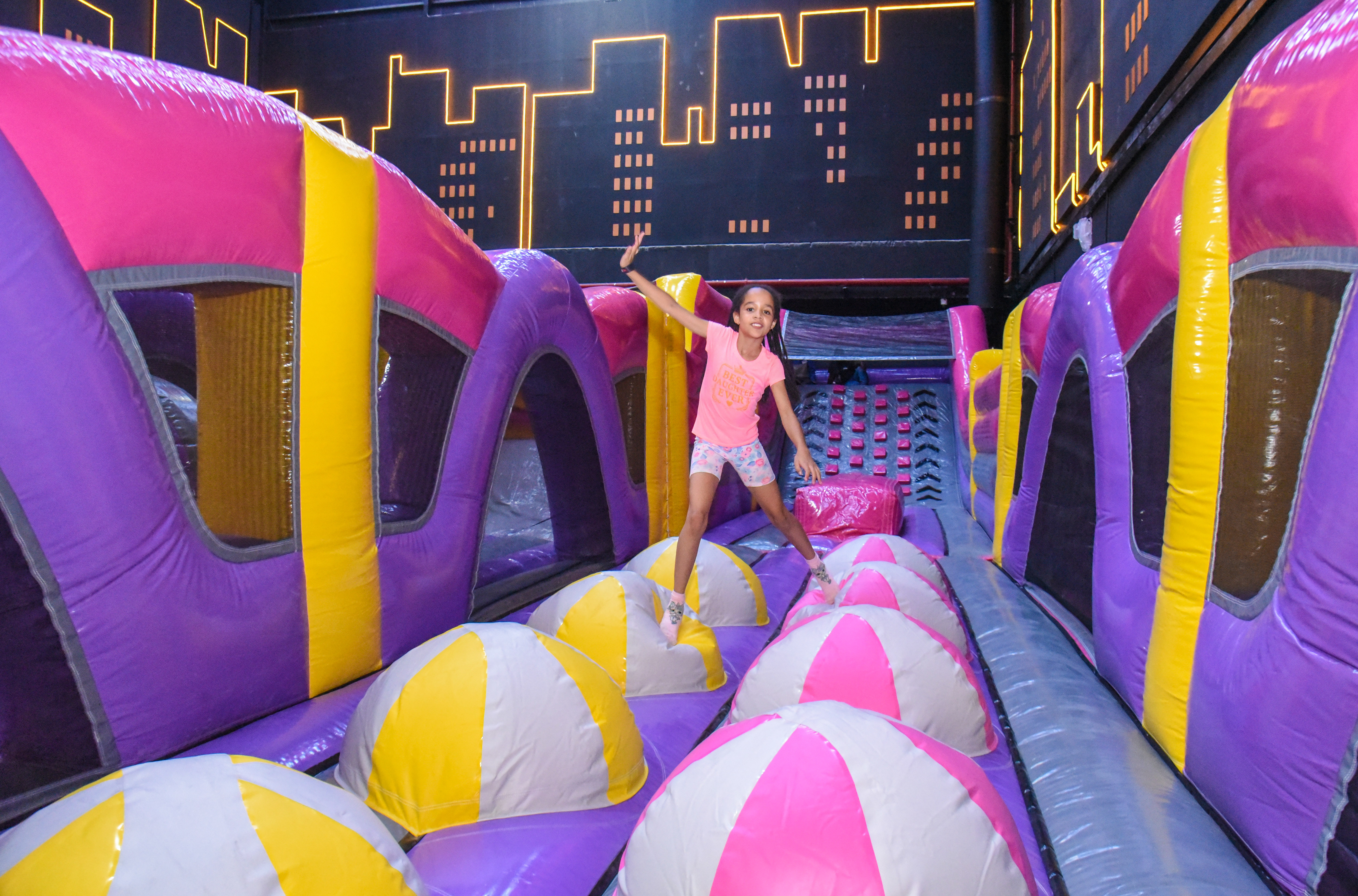 Guest landing on Bag Jump at The Hub Park, a bounce place and game center near me with fun zones for all.