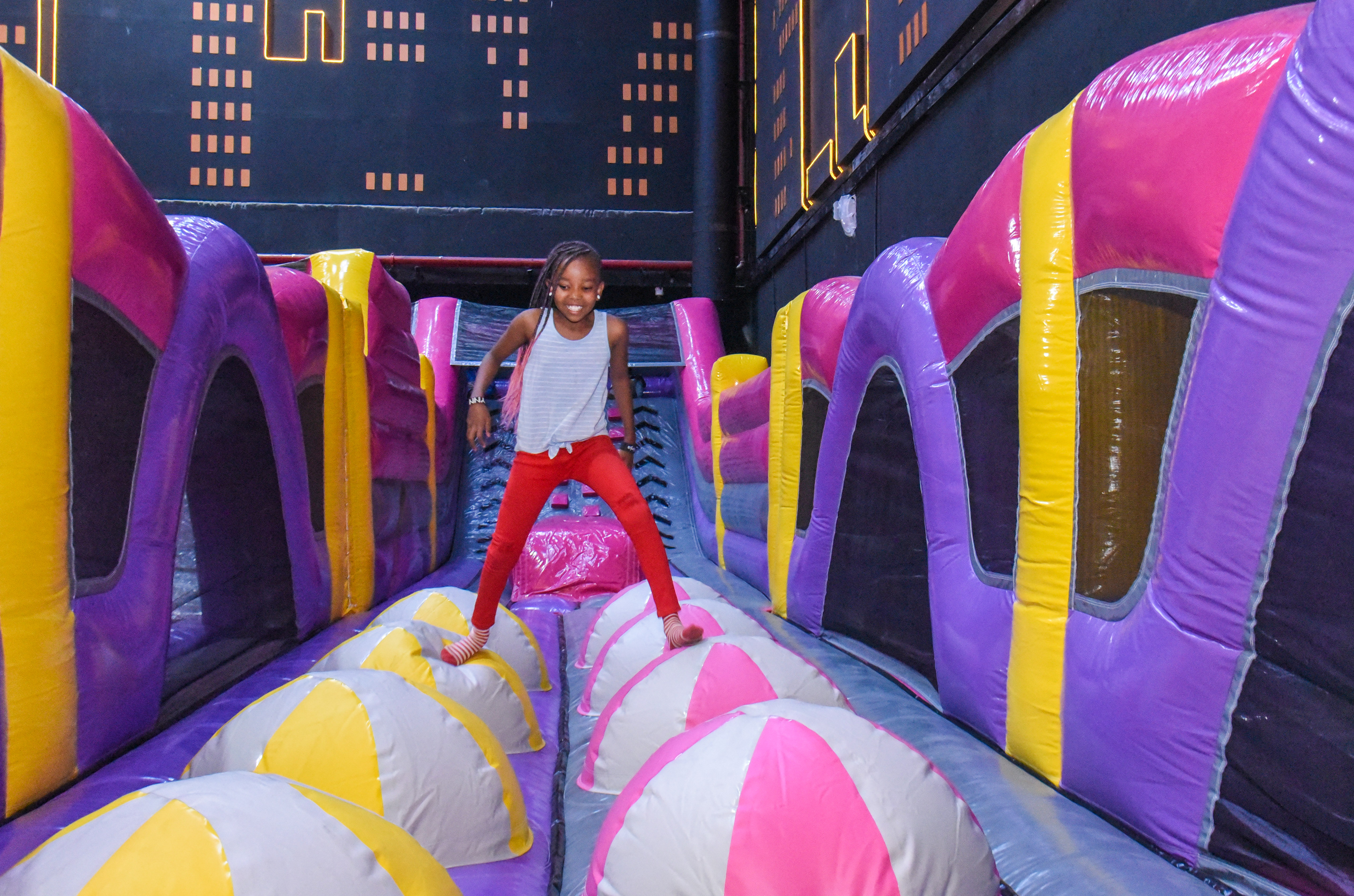 Guest landing on Bag Jump at The Hub Park, a bounce place and game center near me with fun zones for all.