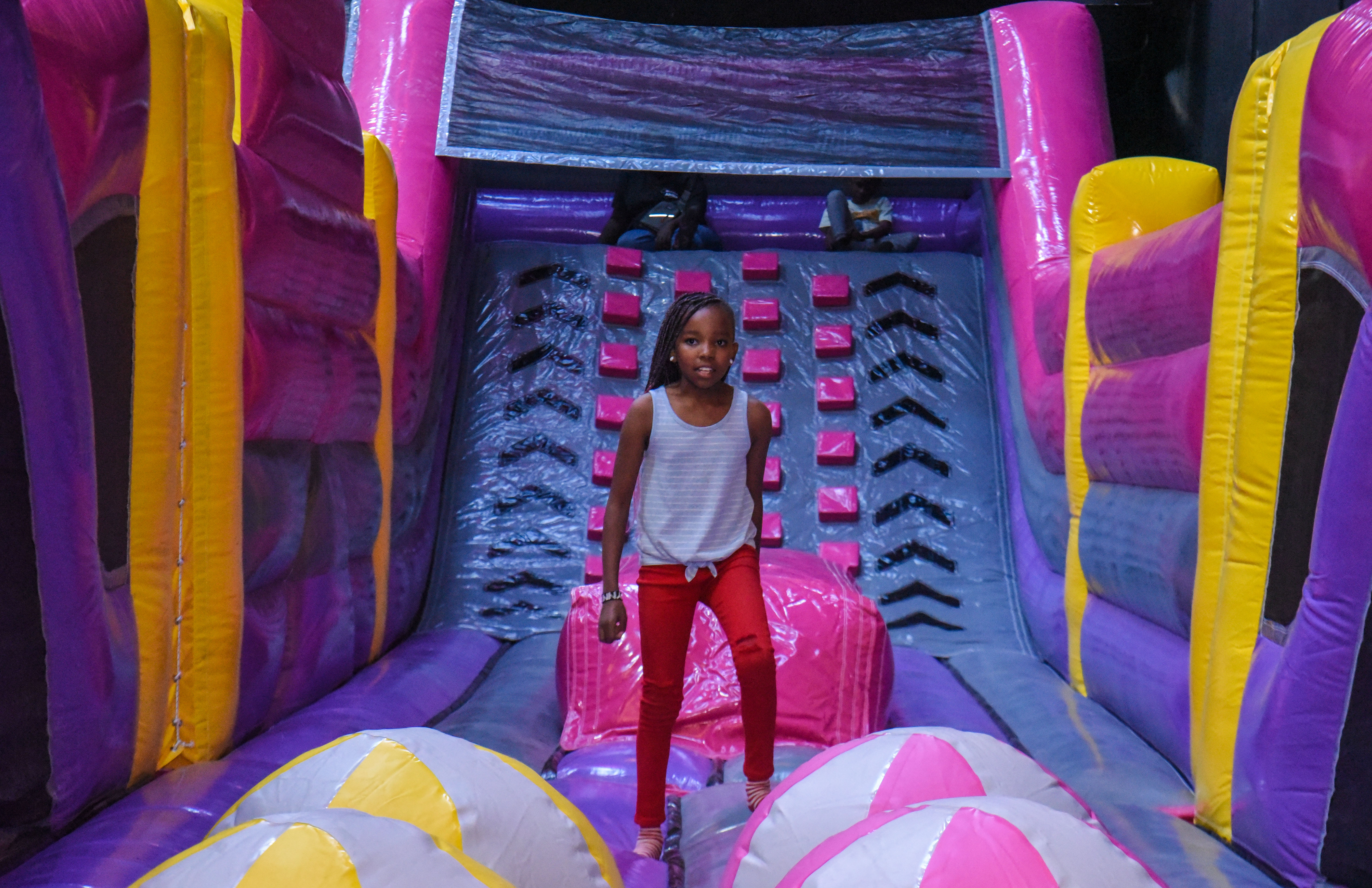 Guest landing on Bag Jump at The Hub Park, a bounce place and game center near me with fun zones for all.