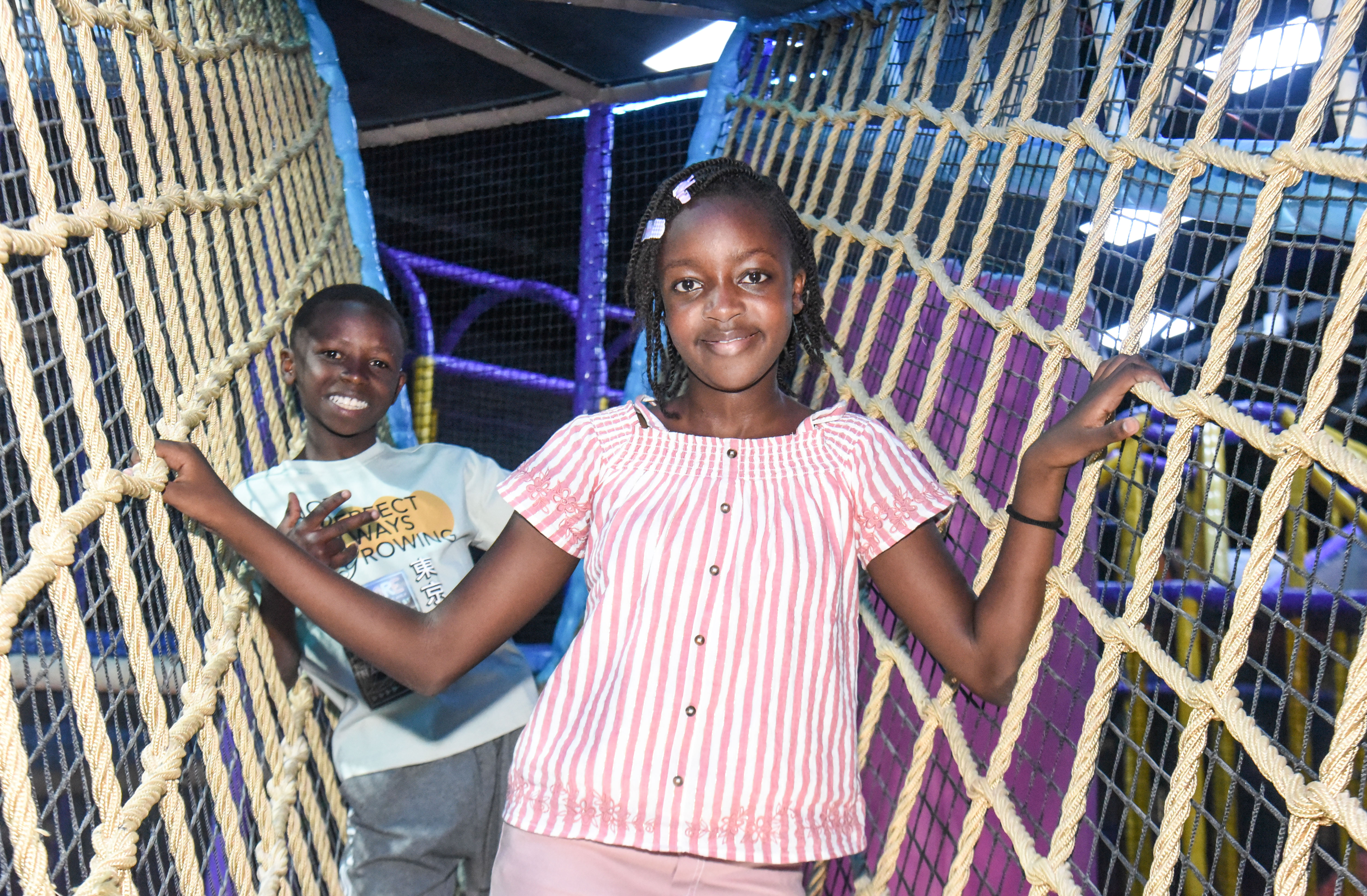 Child balancing in the net maze challenge at The Hub Park, a thrilling indoor fun zone and bounce place.