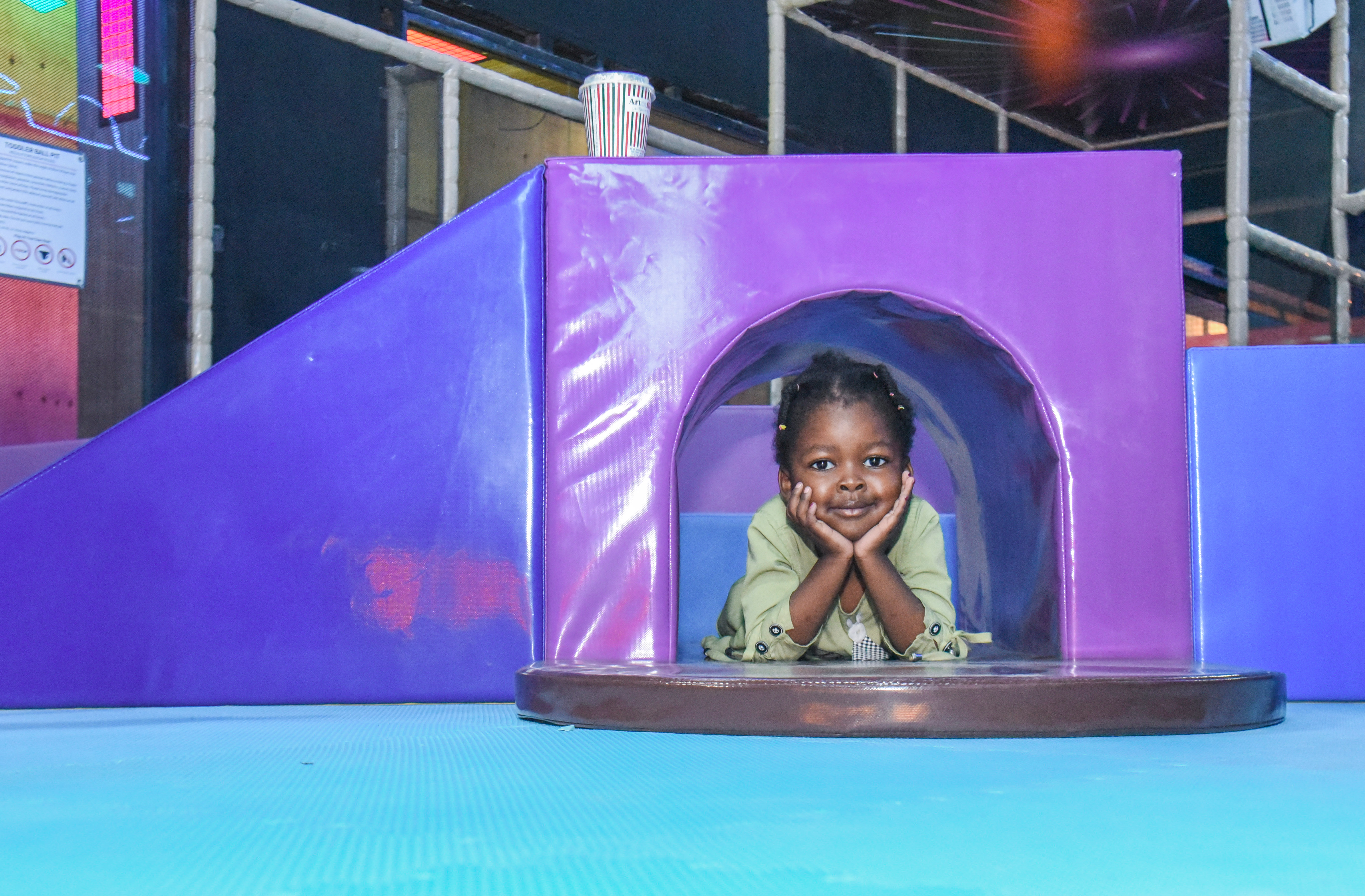 Smiling toddler enjoying safe and fun activities at The Hub Park, a happy family fun center and indoor play arena.