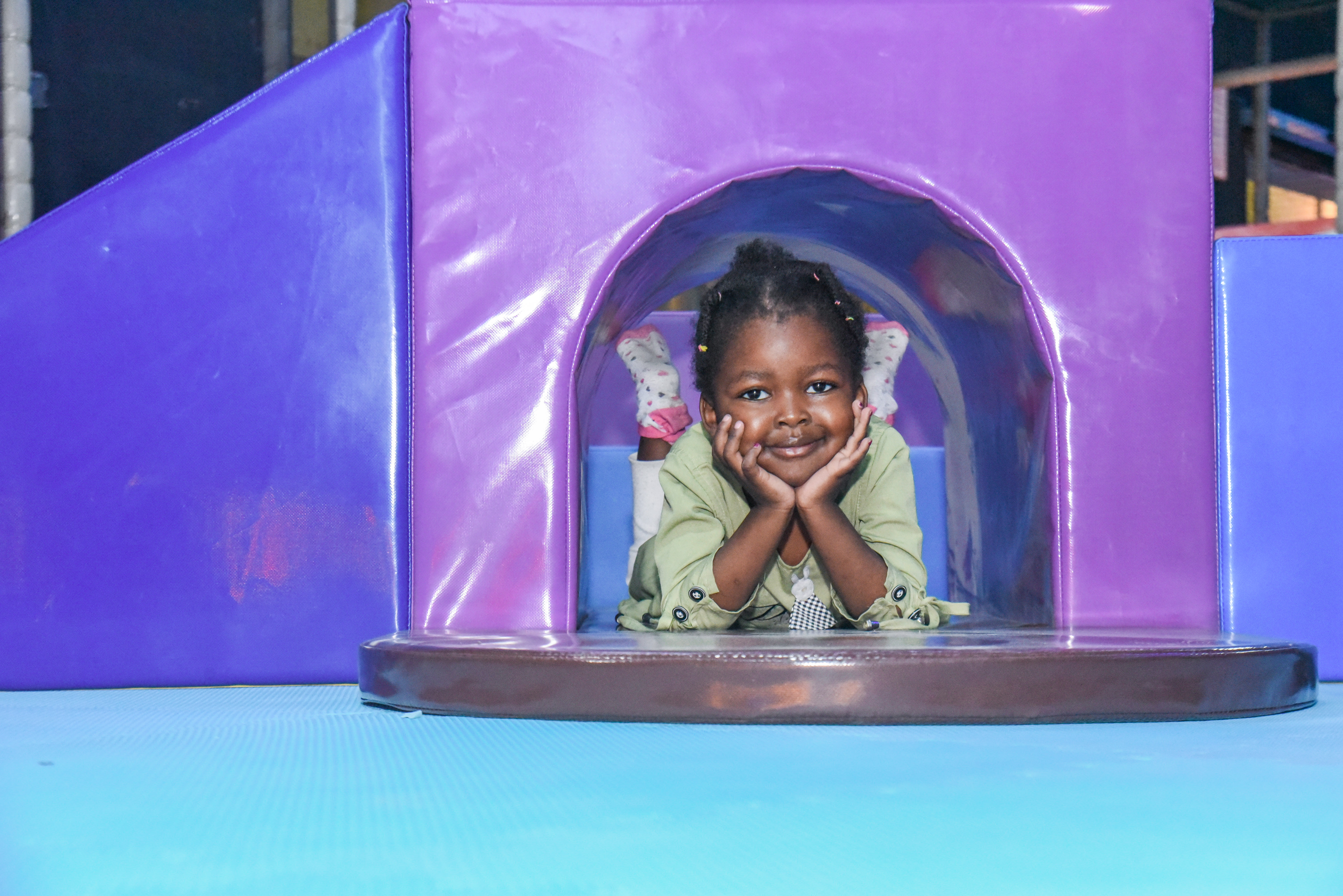 Smiling toddler enjoying safe and fun activities at The Hub Park, a happy family fun center and indoor play arena.