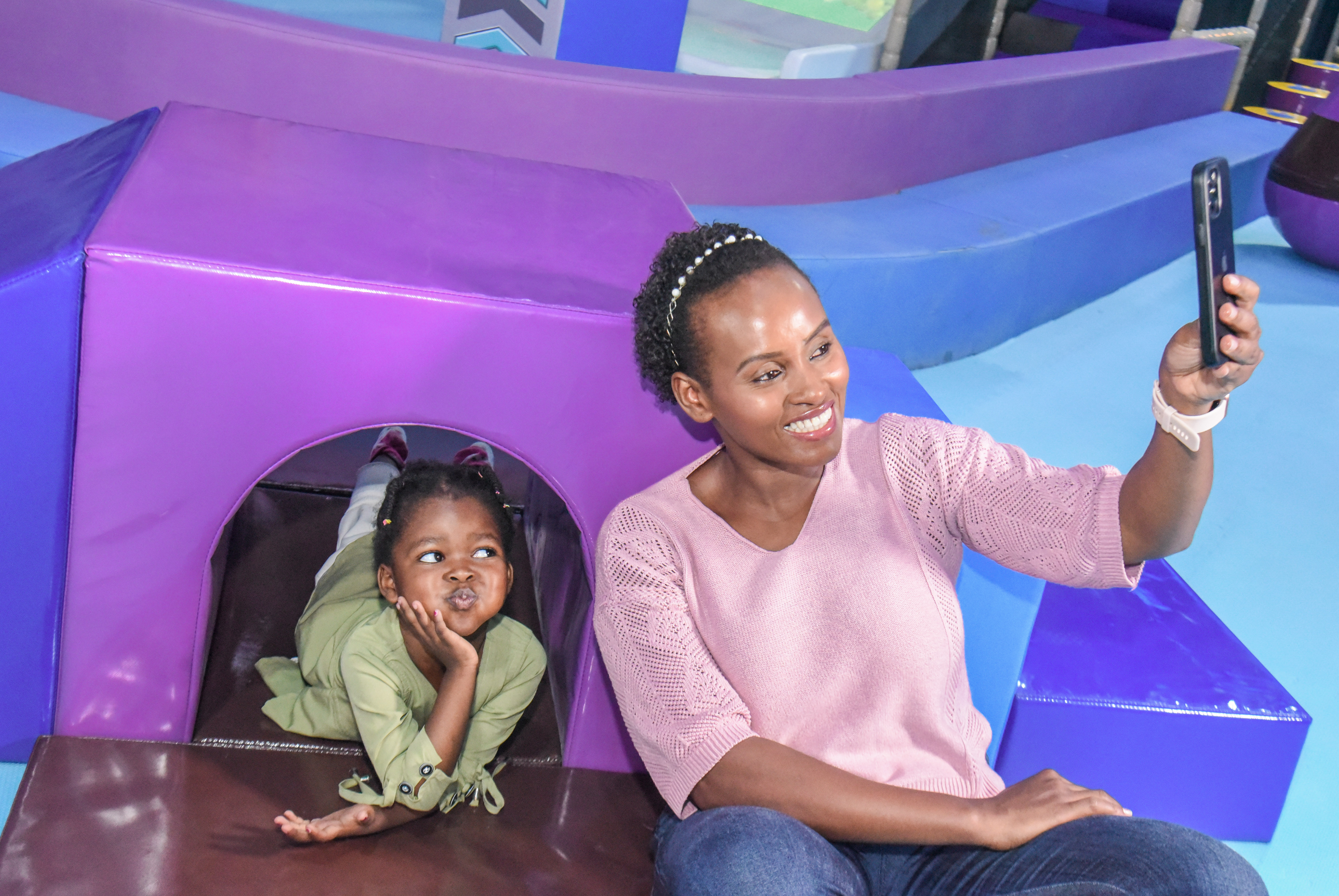 Smiling toddler enjoying safe and fun activities at The Hub Park, a happy family fun center and indoor play arena.
