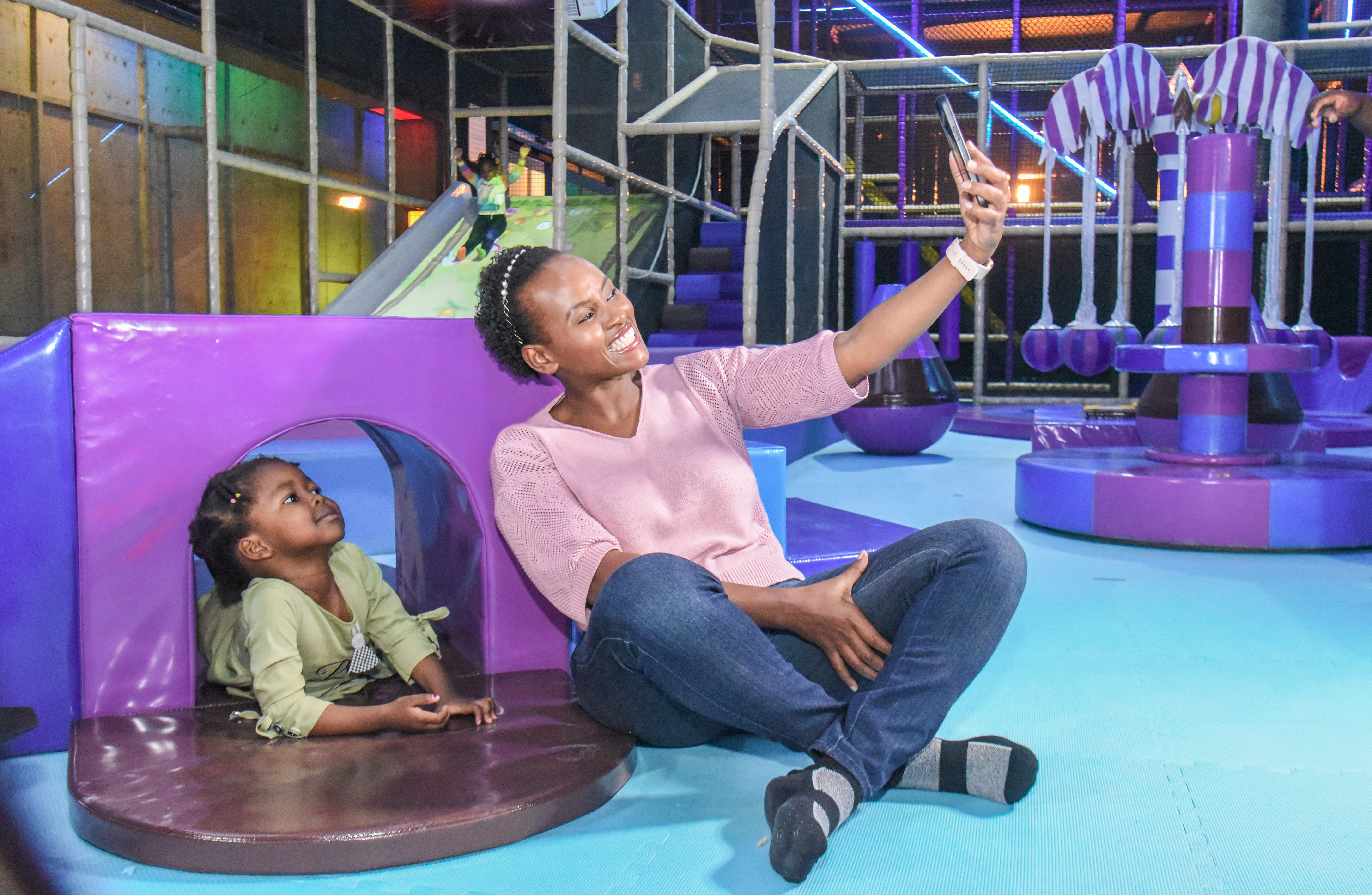 Smiling toddler enjoying safe and fun activities at The Hub Park, a happy family fun center and indoor play arena.