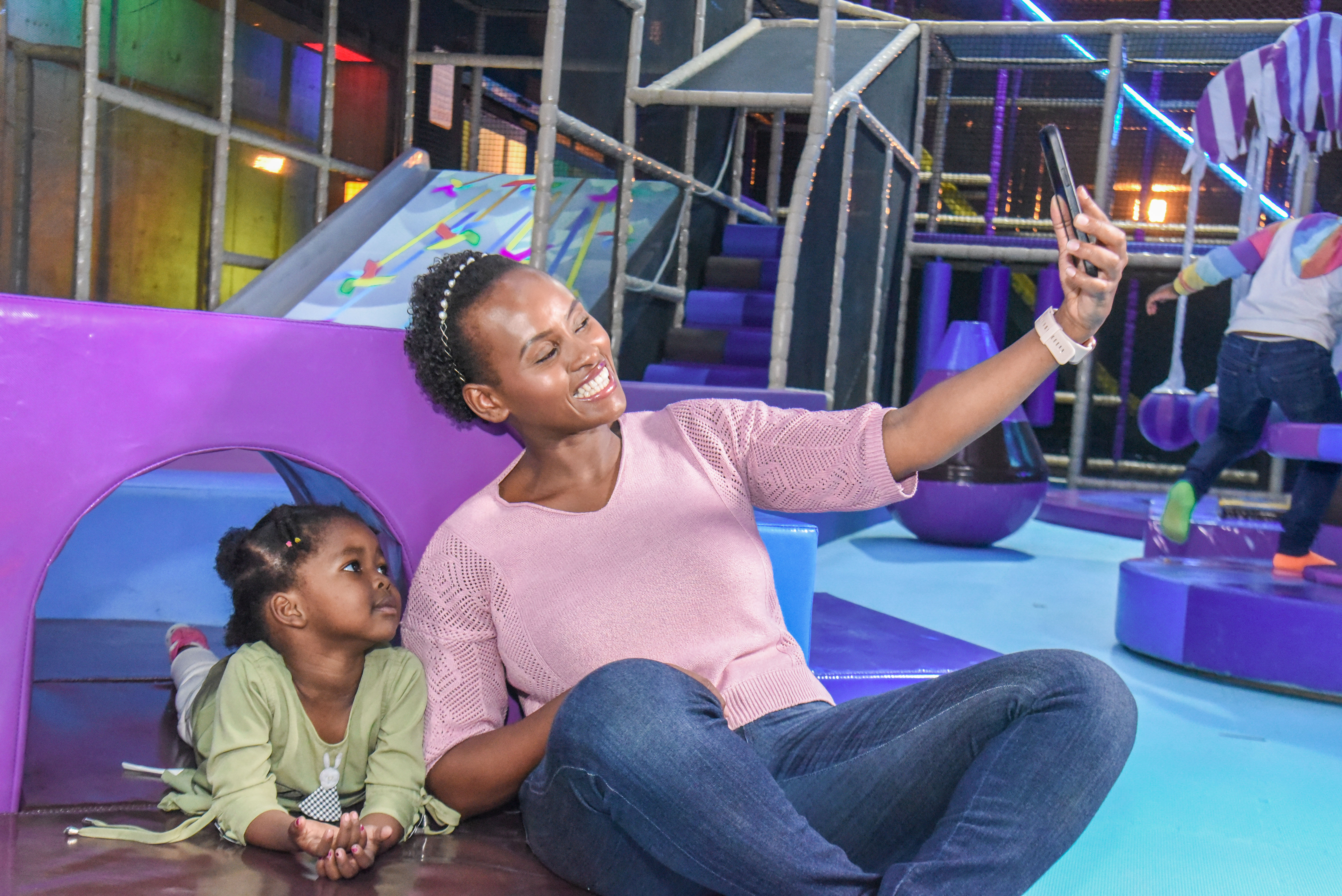 Smiling toddler enjoying safe and fun activities at The Hub Park, a happy family fun center and indoor play arena.